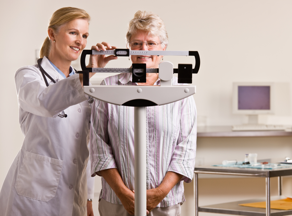 Middle-aged woman being weighed